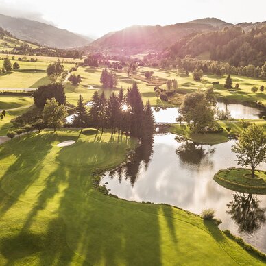 Aerial view of a golf course with ponds and an island