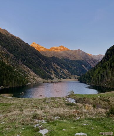 Mountain valley with a lake surrounded by forested slopes