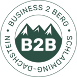 Runder Stempel mit Bergsilhouetten und B2B-Buchstaben