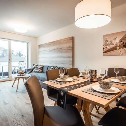 Offener Wohn- und Essbereich mit verschneitem Balkonblick