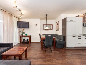 Open-plan living area with dining table and kitchen