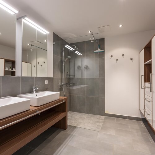 Modern bathroom with double sinks and a glass shower