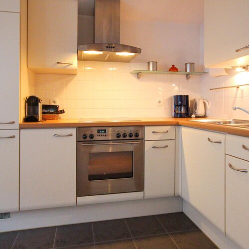 Modern white kitchen with stainless steel appliances