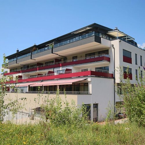 Modernes Mehrfamilienhaus mit mehreren Balkonen und Terrassen