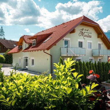 Apartment house Martina with red roof in alpine setting