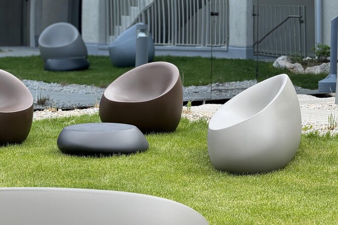 Group of contemporary egg-shaped outdoor chairs on lawn