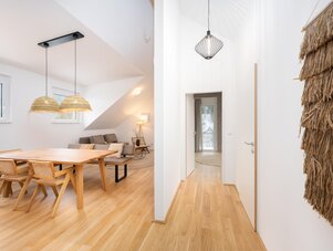 Bright open-plan dining area with wooden table and chairs
