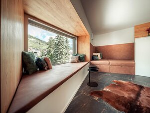 Built-in window bench with cushions and mountain view