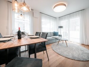 Modern living and dining area with wooden table setting