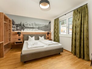 Hotel bedroom with double bed and wood accents