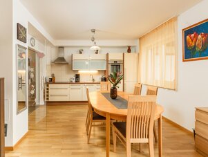 Bright kitchen and dining area with wooden table and chairs