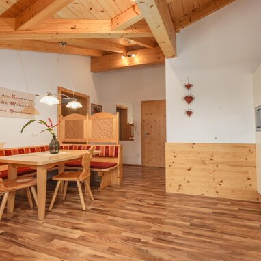 Wooden dining area with red upholstered bench seating