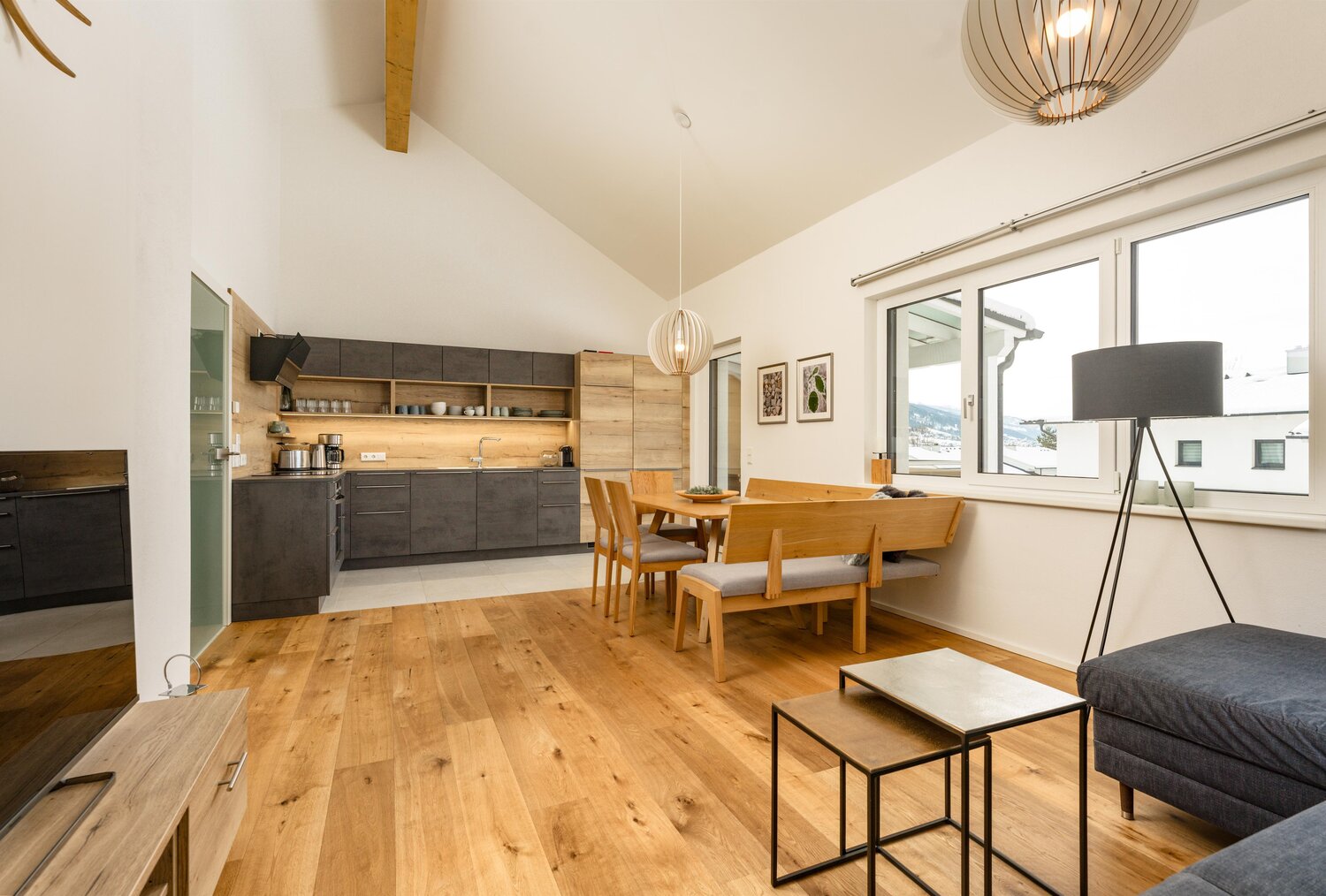 Open-plan kitchen and dining area with wooden furniture