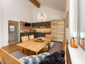 Open-concept kitchen with wooden cabinets and dining table